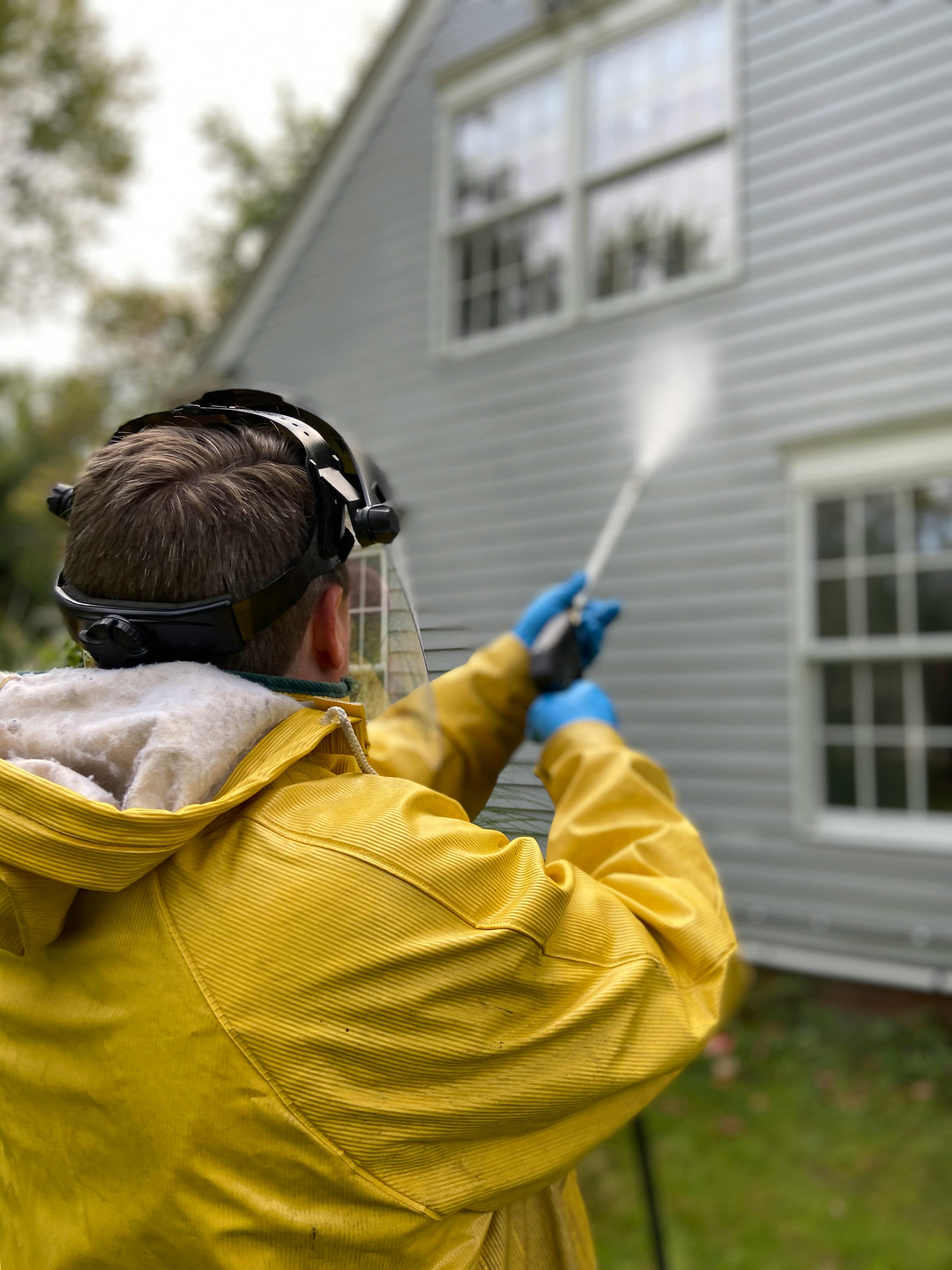 Power washing the siding of a home